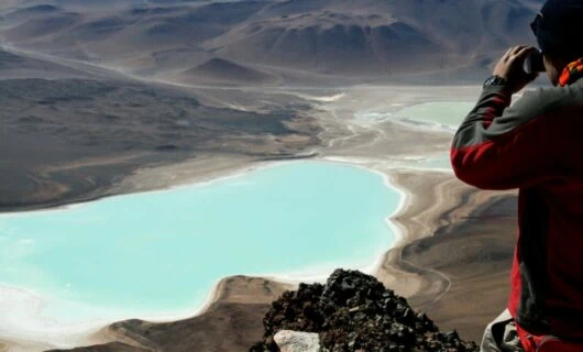 Traveler takes picture of valley lake