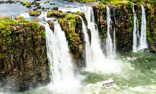 Boats full of tourists below Iguazu Falls