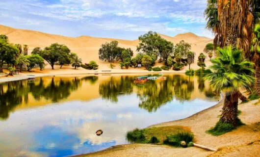 Boats sit on surface of desert oasis