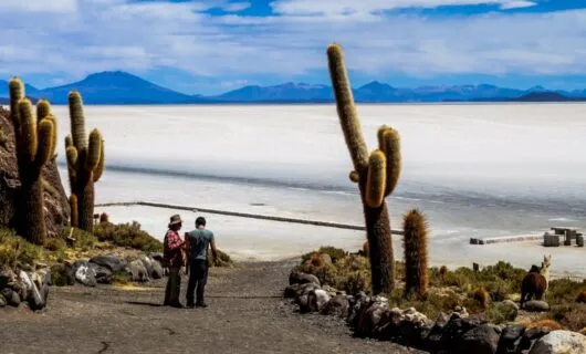 Travelers stand in road leading to Bolivia salt flats