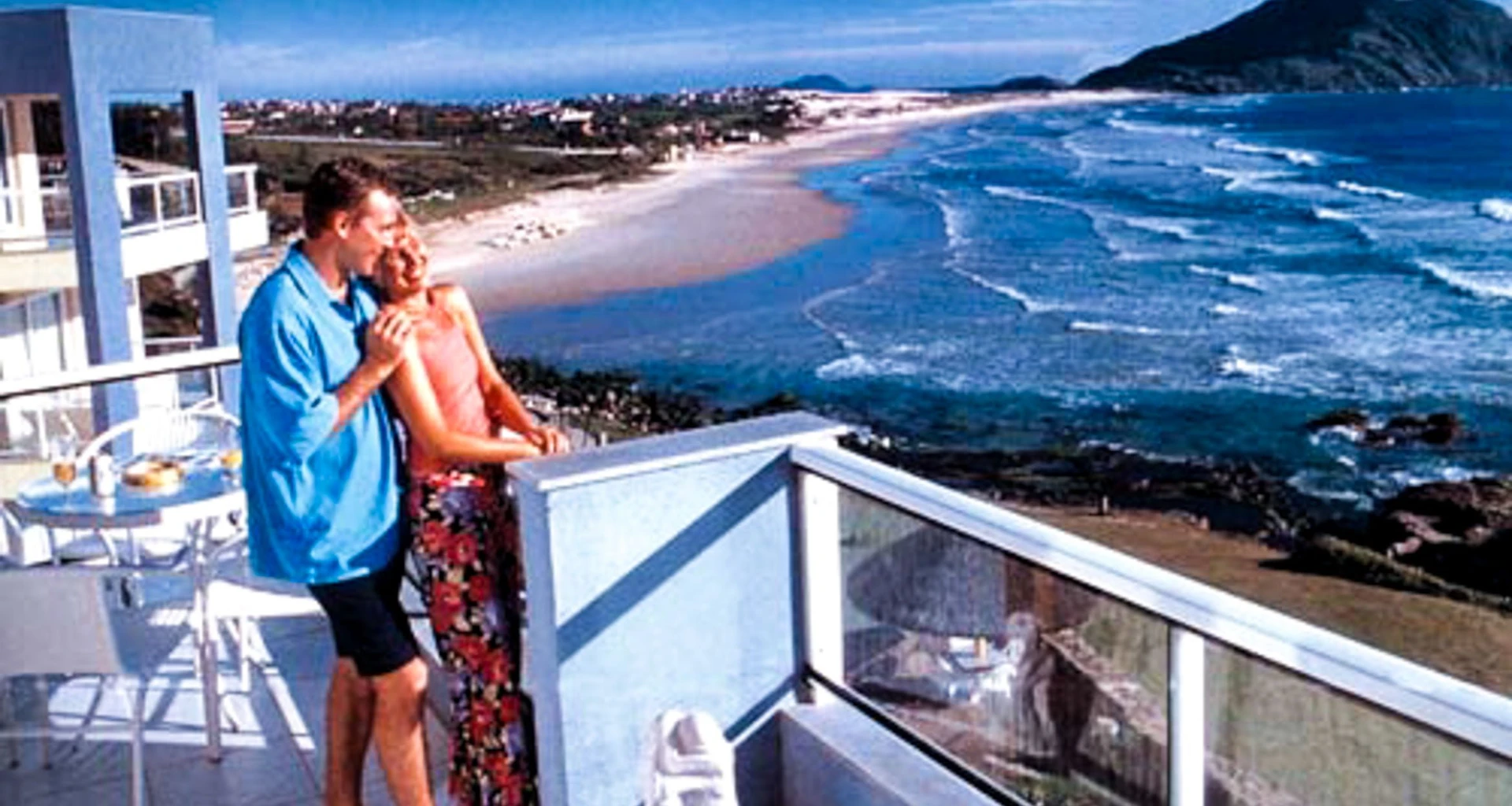 Couple stands on balcony of Costao Santinho Resort