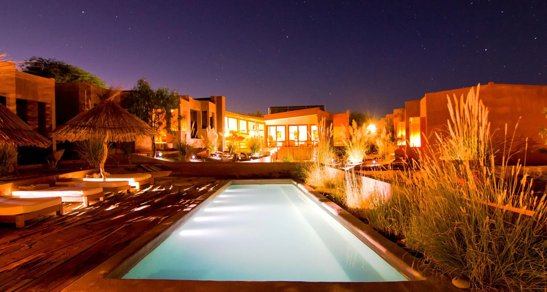 Outdoor pool area at Casa Atacama at night