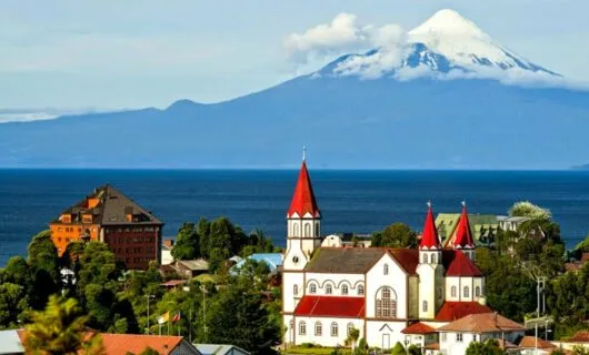old church with view of mountain and water