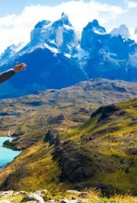 Hiker stands against Torres del Paine on a Chile tour mountains