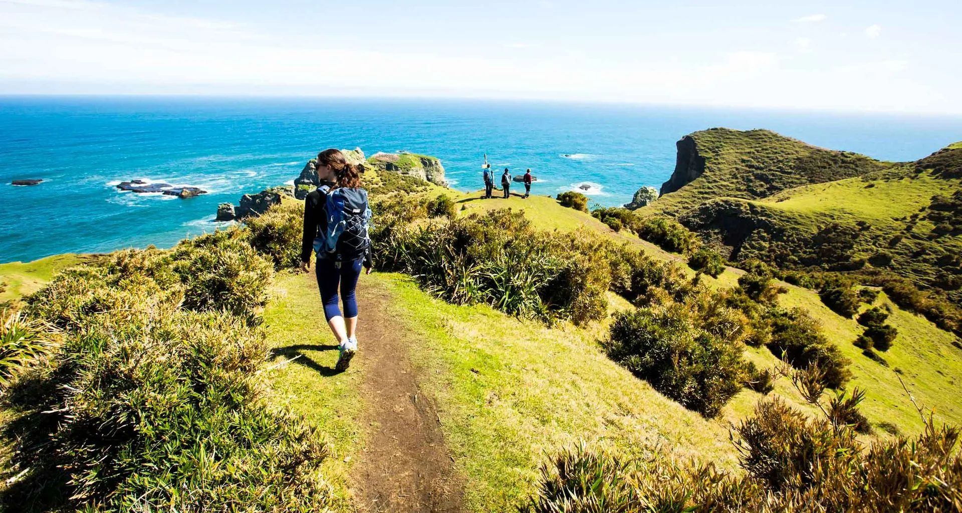 Hikers walk along coast of Chiloe Island
