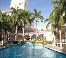 pool and exterior of hotel on a sunny day