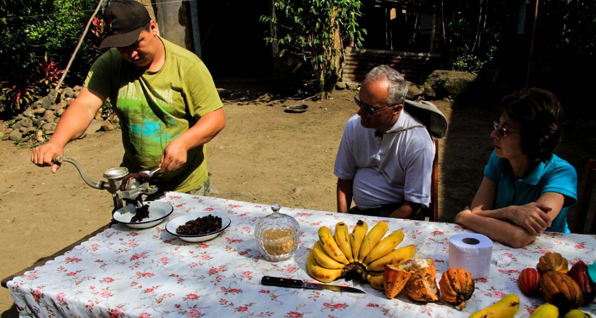Man grinds beans at table