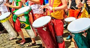 Group of performers play colorful drums