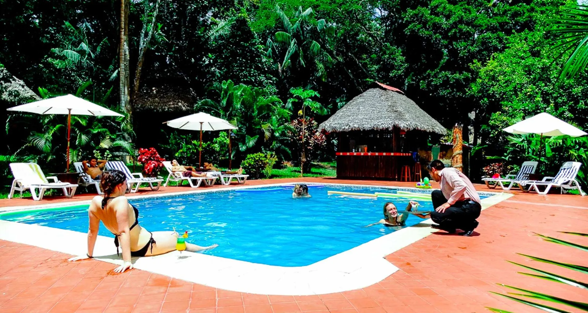 Travelers lounge around Corto Maltes outdoor pool