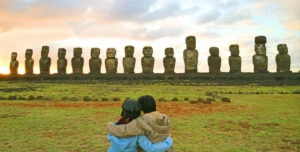 couple looking at the moai statues in easter island