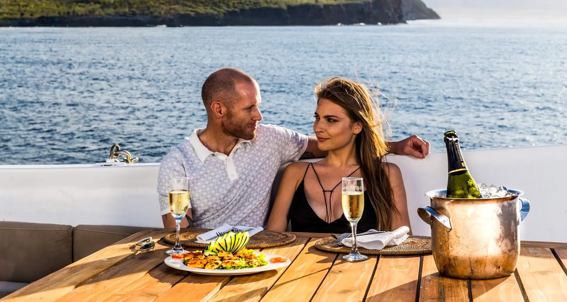 Couple enjoys meal on deck of cruise ship