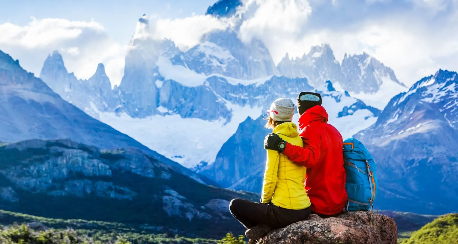 Couple sits on rock overlooking Torres del Paine