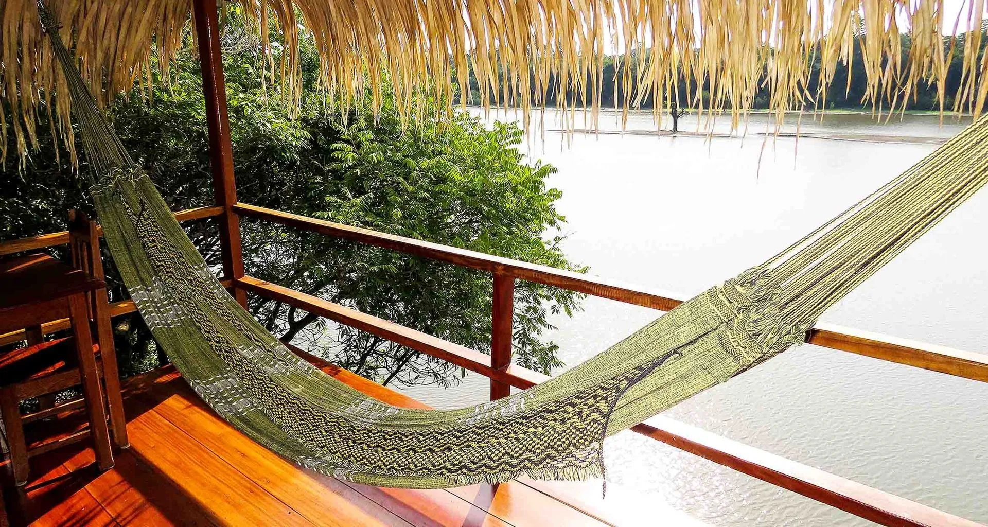 Hammock hangs on deck near river