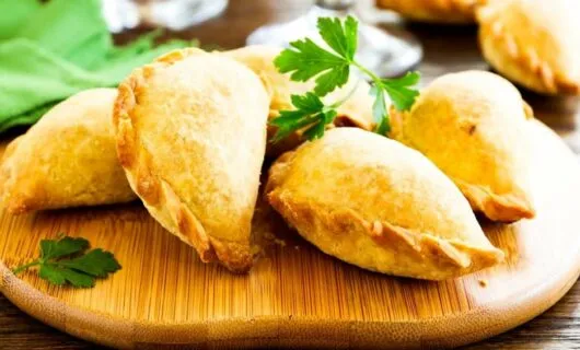 Empanadas on wooden platter