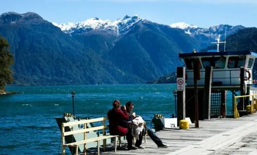 Travelers sit on ferry dock