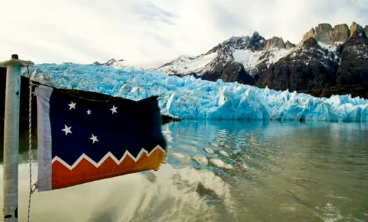 Flag in front of Patagonia glacier