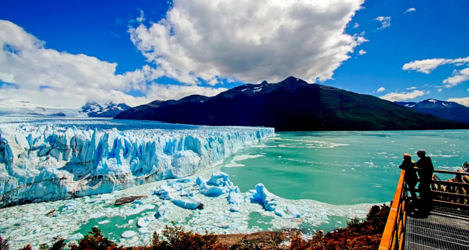 Travelers look at glacier from viewing platform