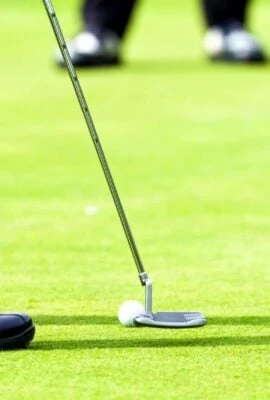 Man putts on golf green