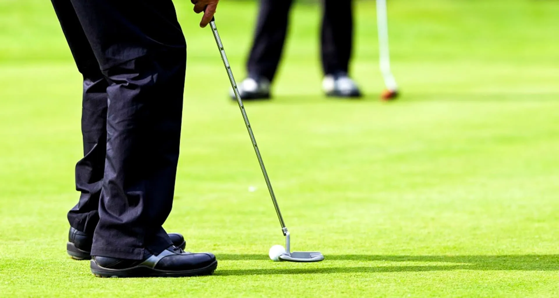 Man putts on golf green