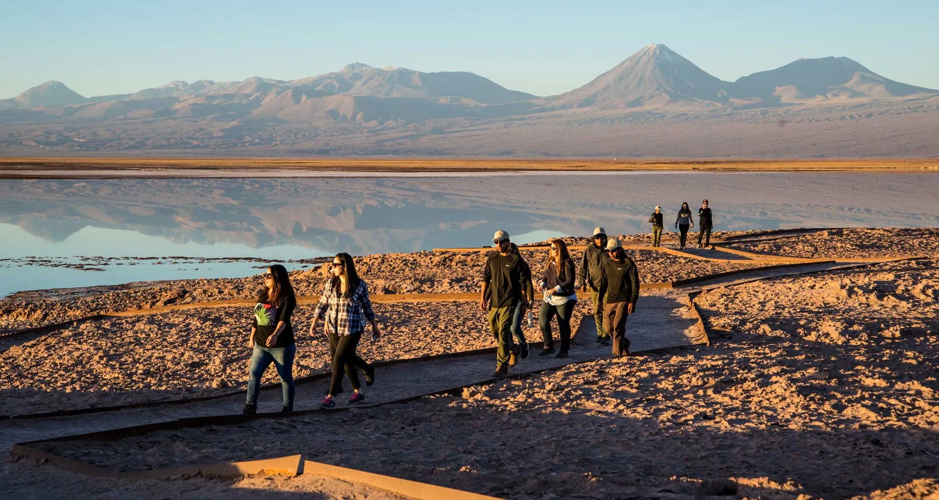 Hiking group on desert path near mountains