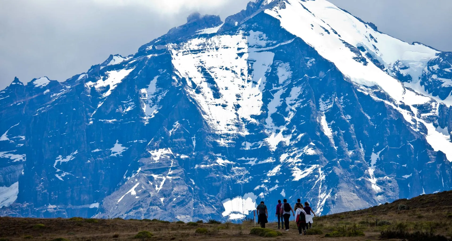 Hiking group in front of large mountain