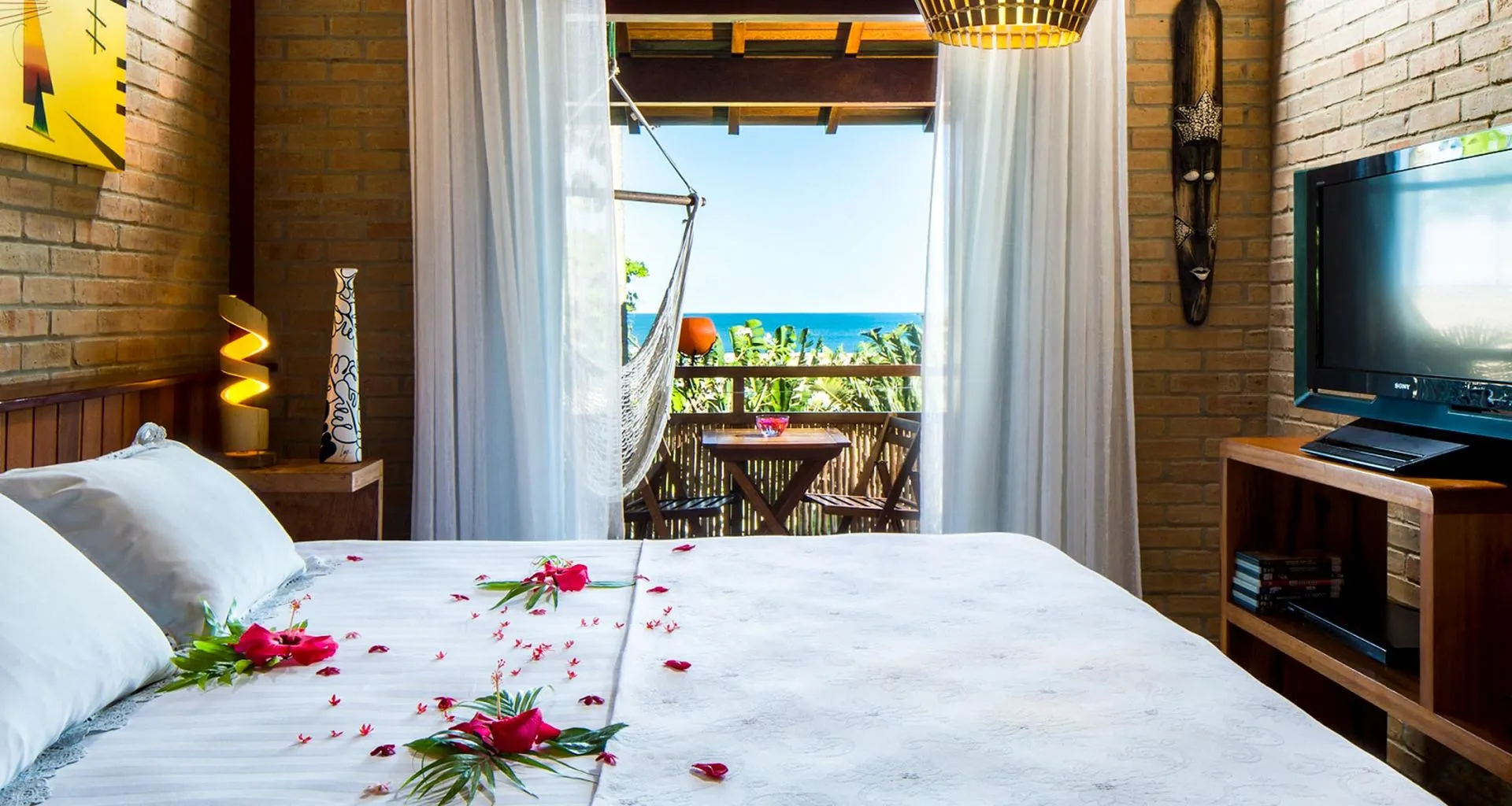 Rose petals on bed in honeymoon suite