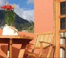 Balcony chair and table outside of the Hotel Casa Deco Bogota