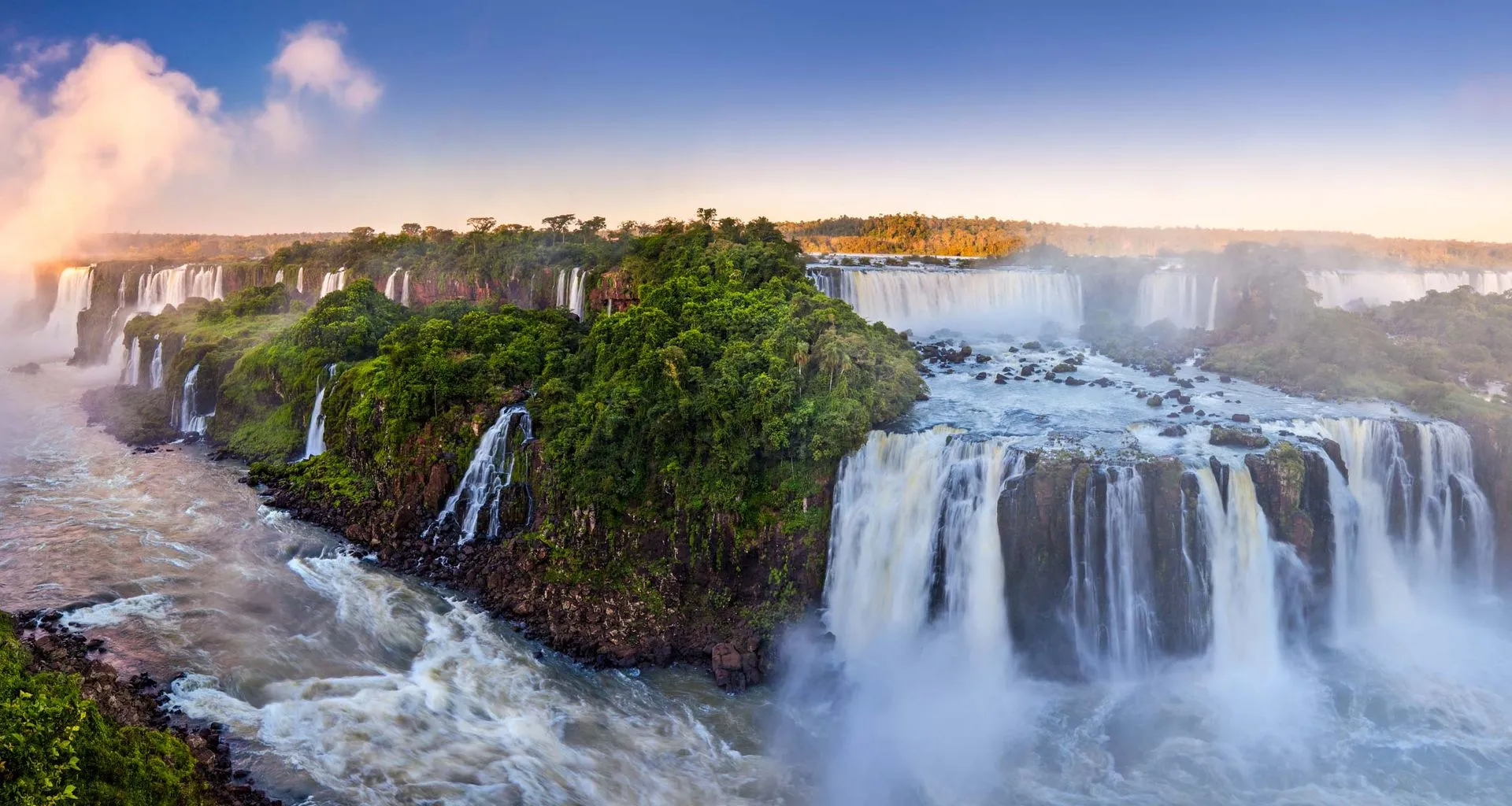 Panoramic view of Iguazu Falls at sunset