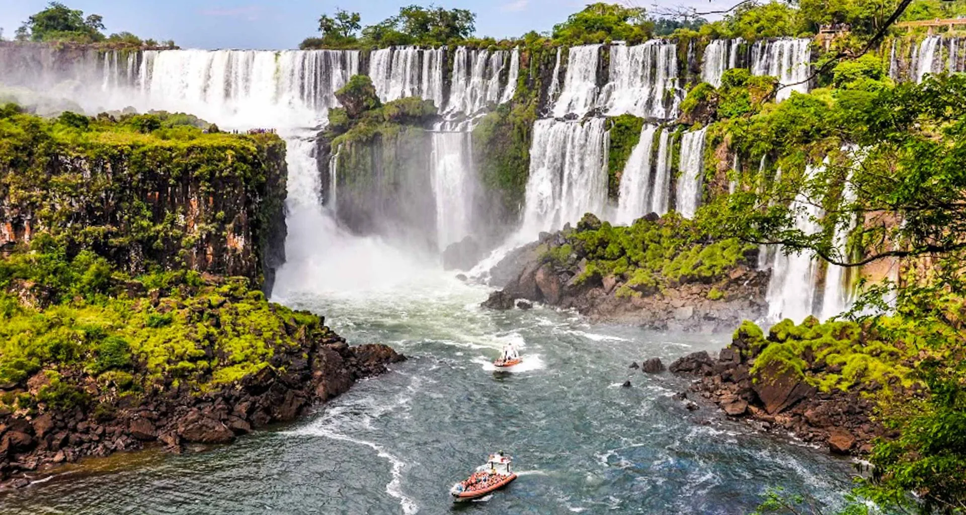 Two boats approach base of Iguazu Falls