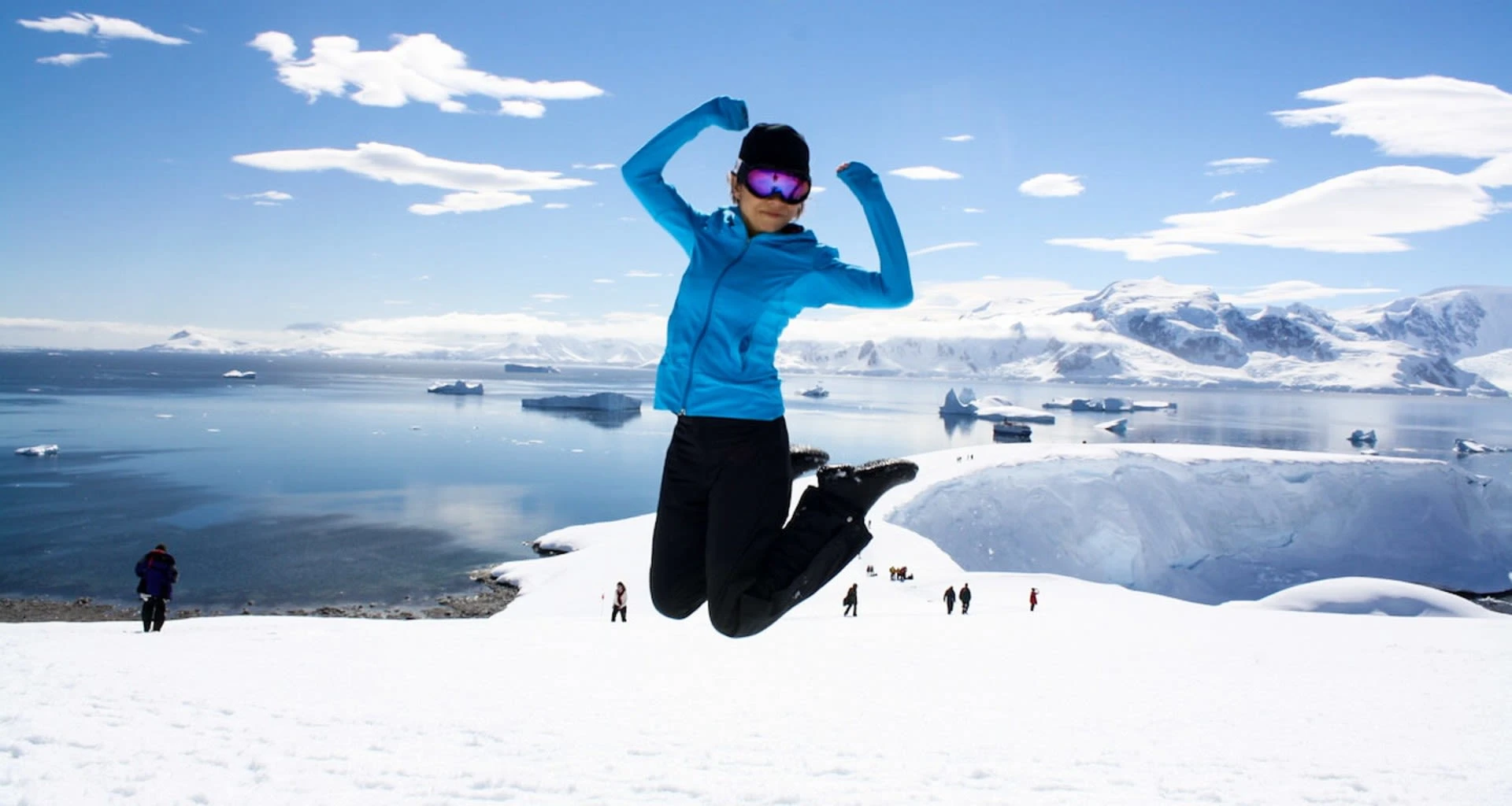 Woman in mid-jump in Antarctica