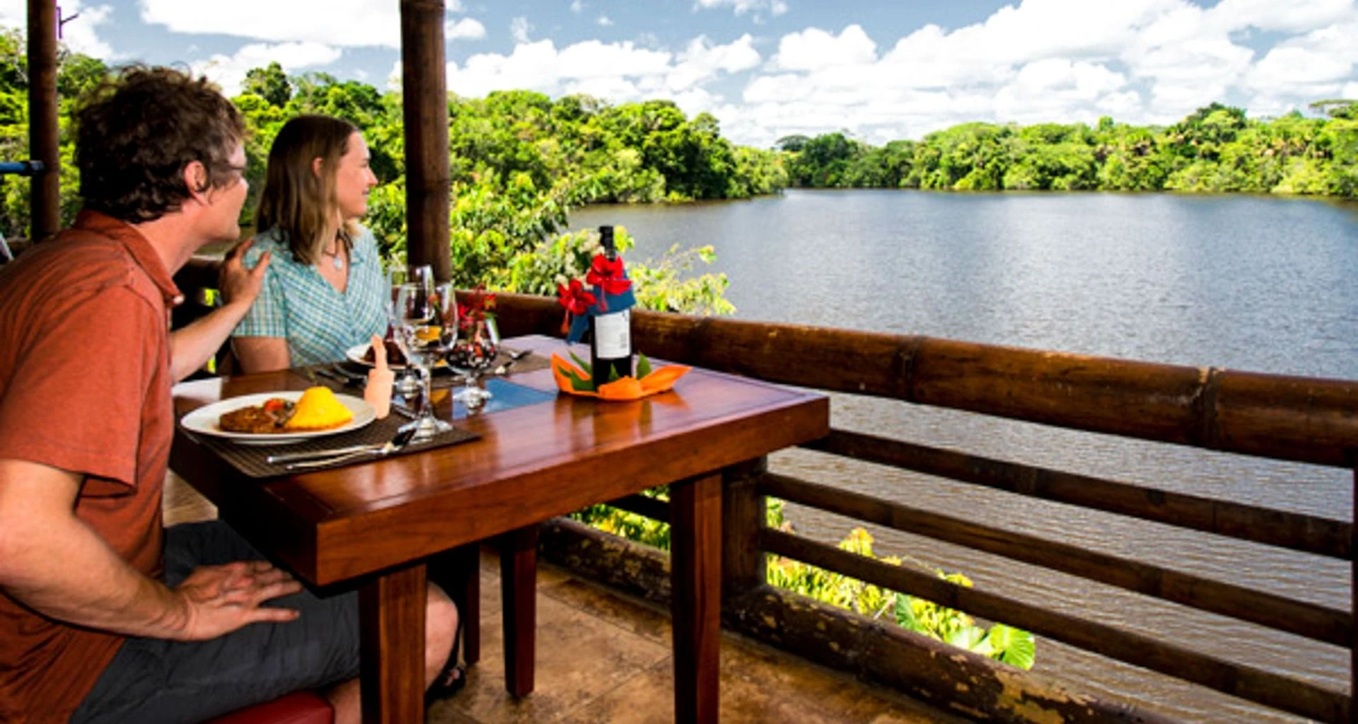 Travelers enjoy lunch on deck of La Selva Amazon Lodge