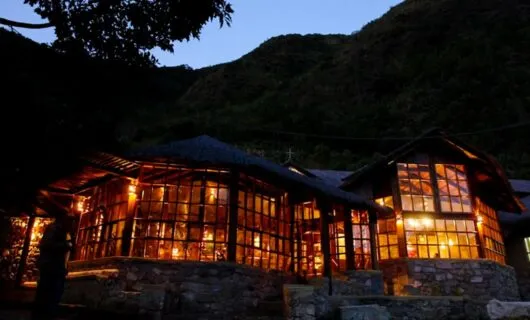Exterior view of lit lodge windows at night