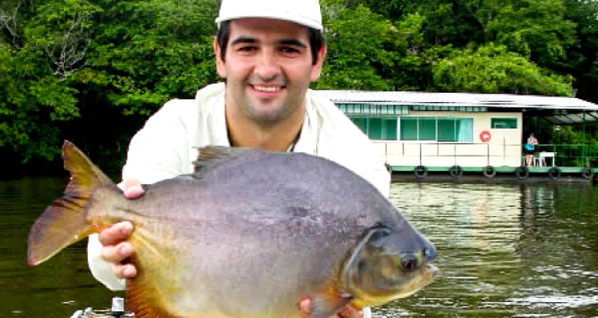 Man holds fish in Brazil Pantanal