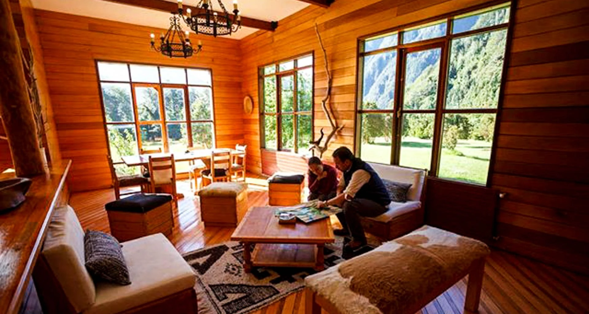 Travelers sit in lounge of Mitico Puelo Lodge