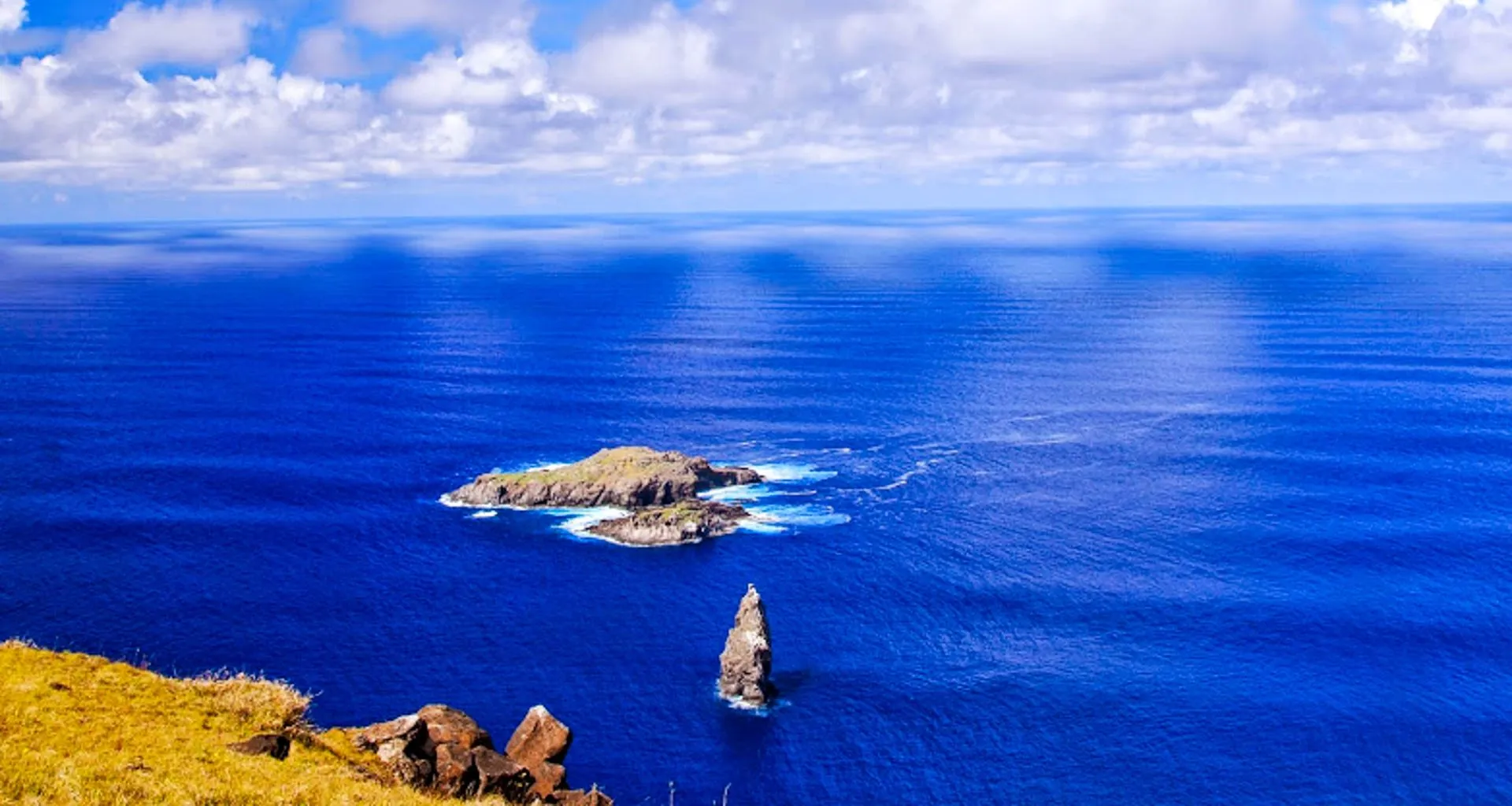 Rocks of Moto Nui Islet in blue ocean