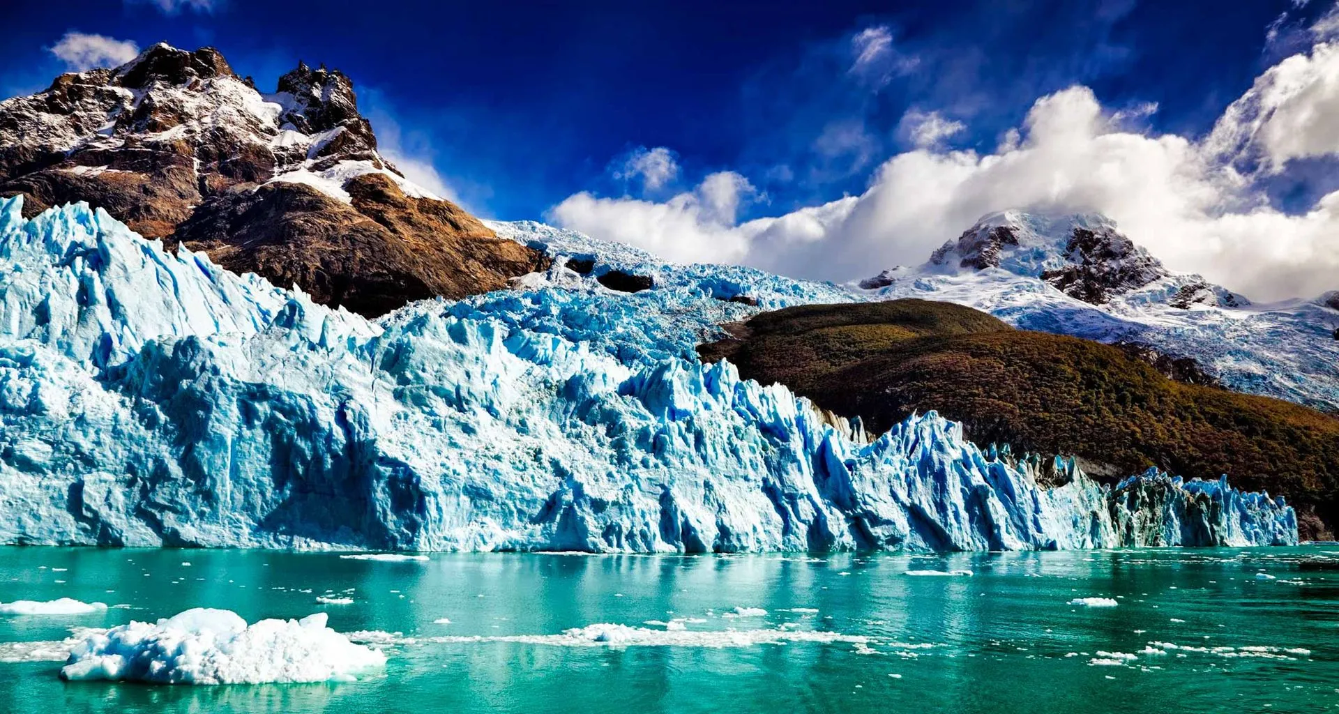 Glacier in water next to mountain