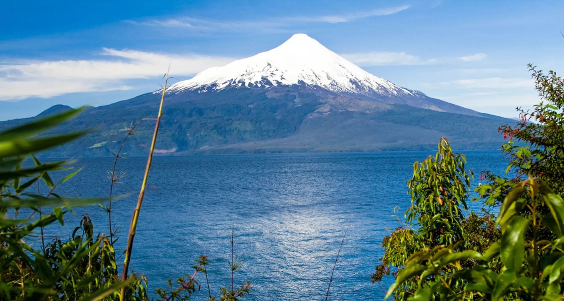 Single mountain peak behind calm lake