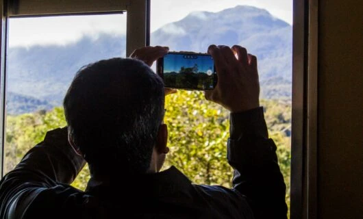 Man takes picture of mountain through phone