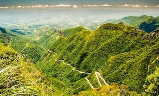 Aerial view of winding road through mountains