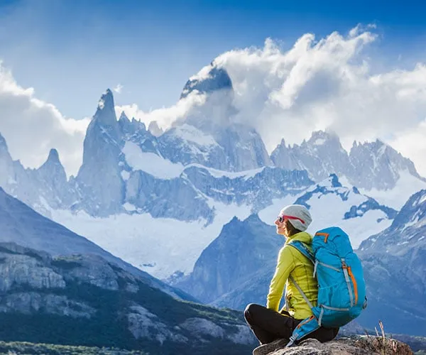 Girl sitting on rock enjoying view of Patagonia 