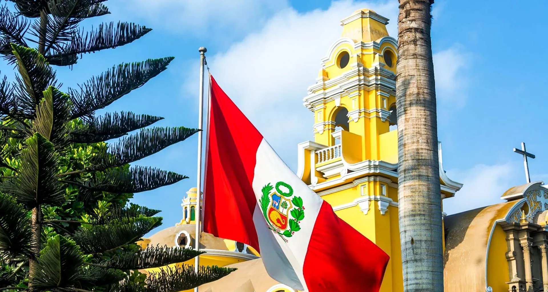 Peru flag in front of yellow building