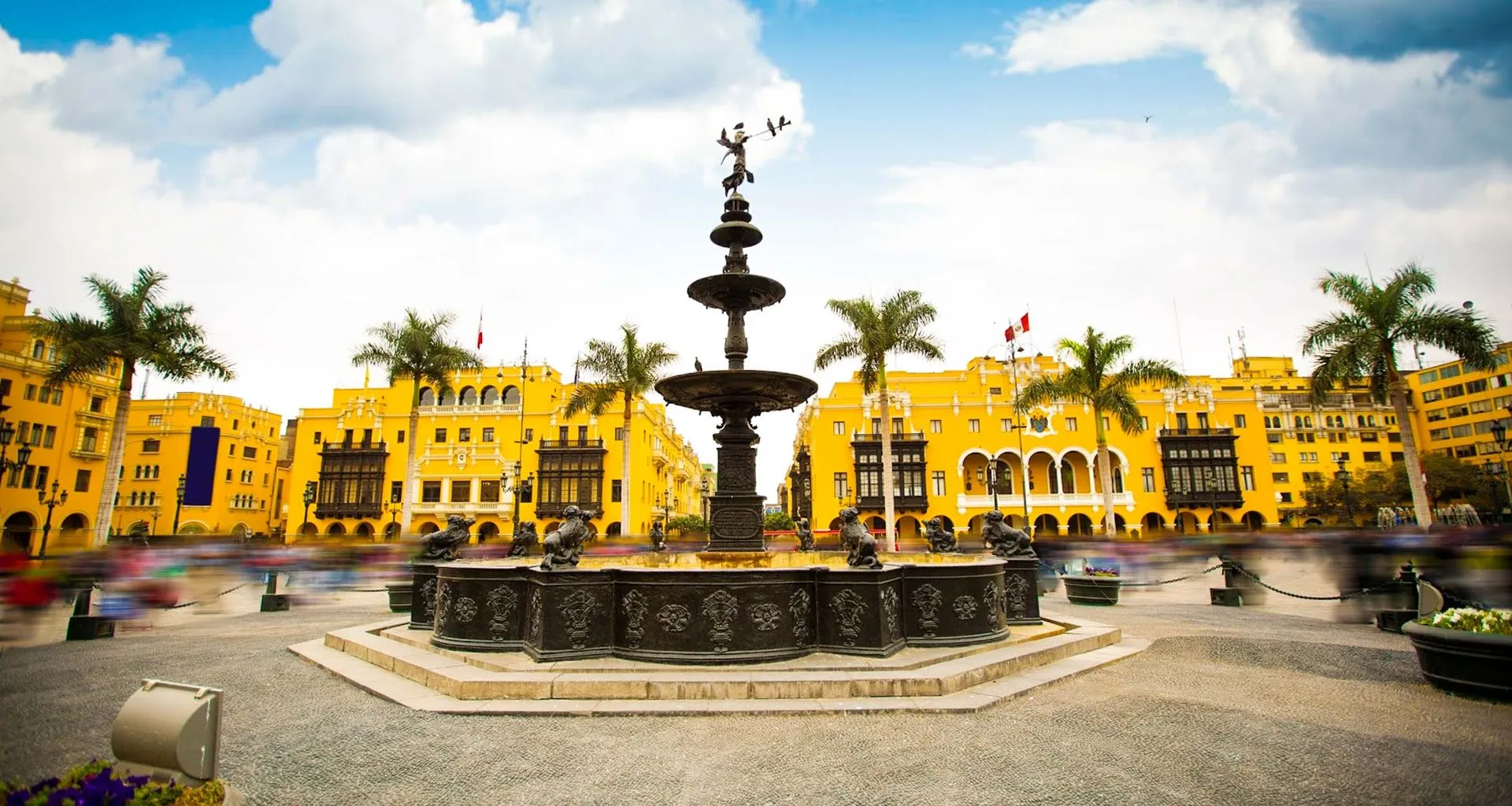 Yellow buildings surrounding Peru fountain plaza