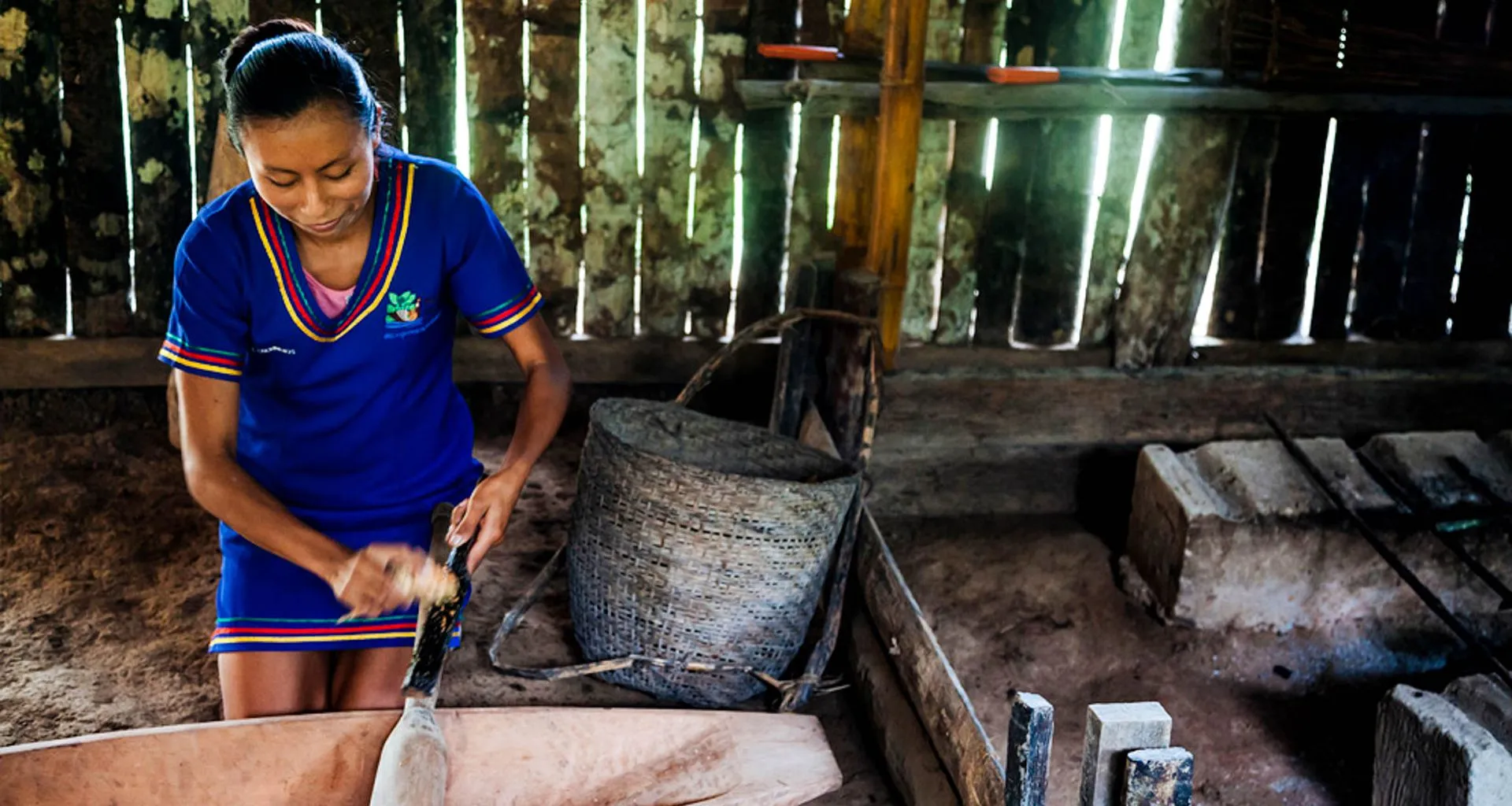 Woman in shed polishes a stick