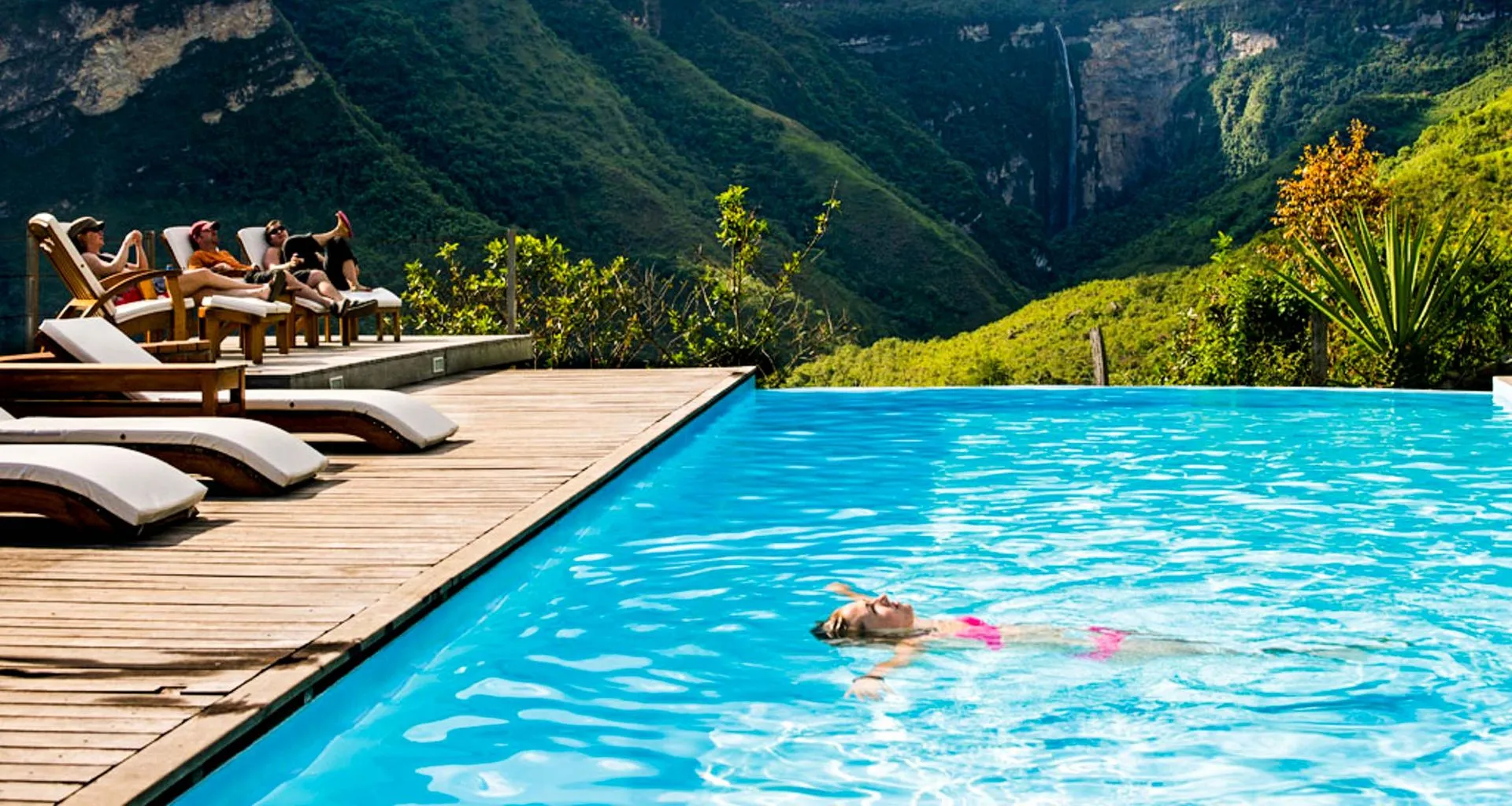Woman floats on her back in resort pool