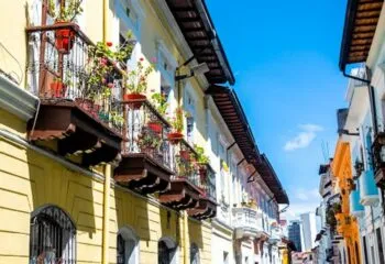 Balconies hanging over the streets of Quito Ecuador decorated by flowers