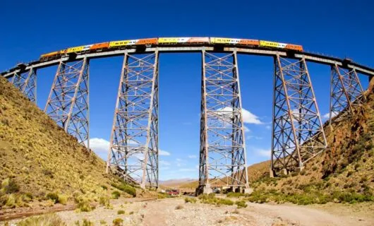 Orange and yellow bridge crosses high bridge
