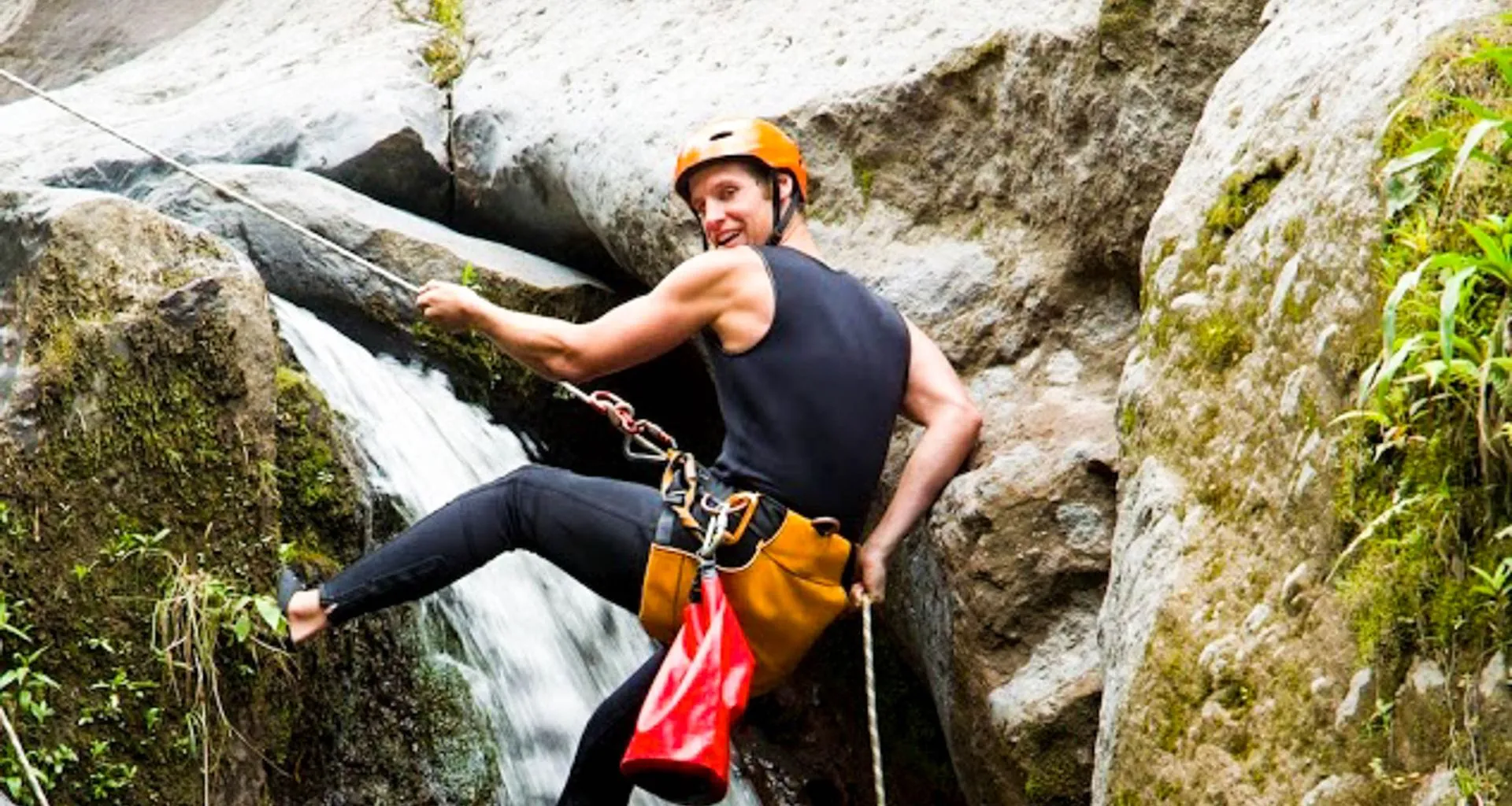 Traveler rappels down waterfall