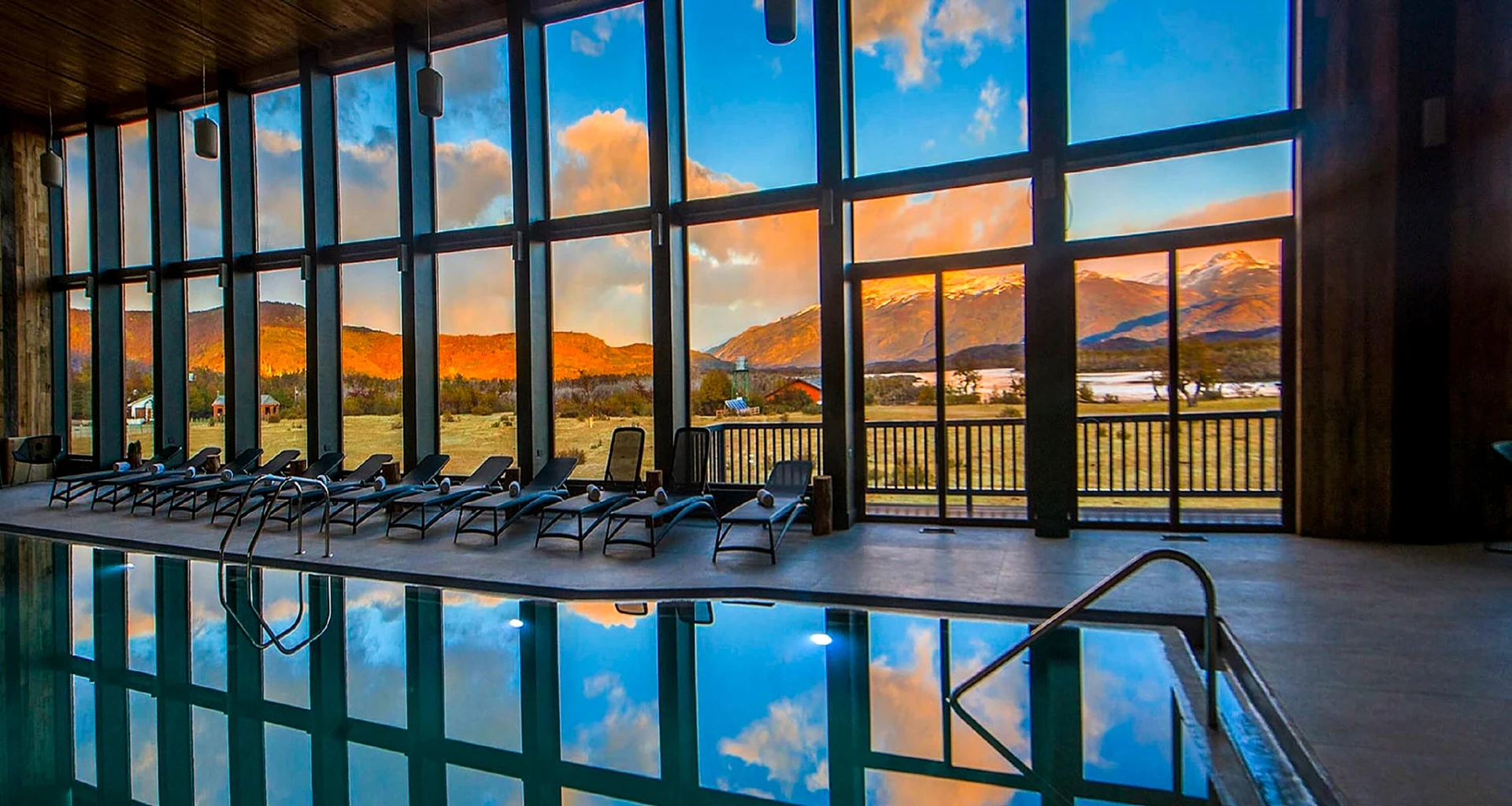 Indoor pool with wall of windows in Rio Serrada Lodge