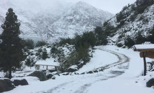 Small road winds through snowy mountains