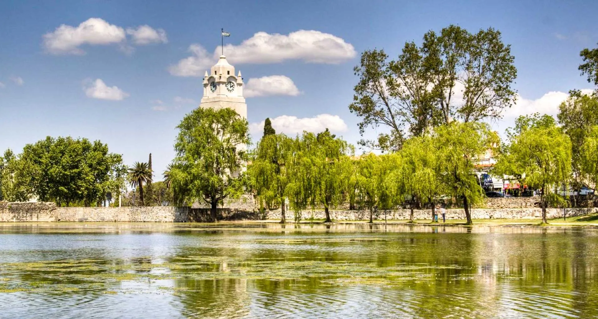 Church spire over treeline near South America river
